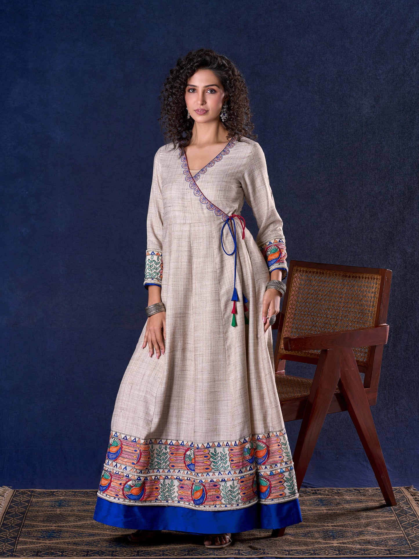 Artisanal Beige Handloom Cotton Angarkha Long Gown with Madhubani Border Embellished Neckline, Sleeve & Flare, with Vibrant Statement Tassels