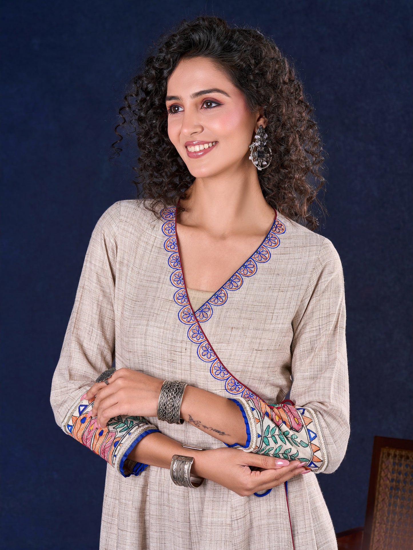 Artisanal Beige Handloom Cotton Angarkha Long Gown with Madhubani Border Embellished Neckline, Sleeve & Flare, with Vibrant Statement Tassels