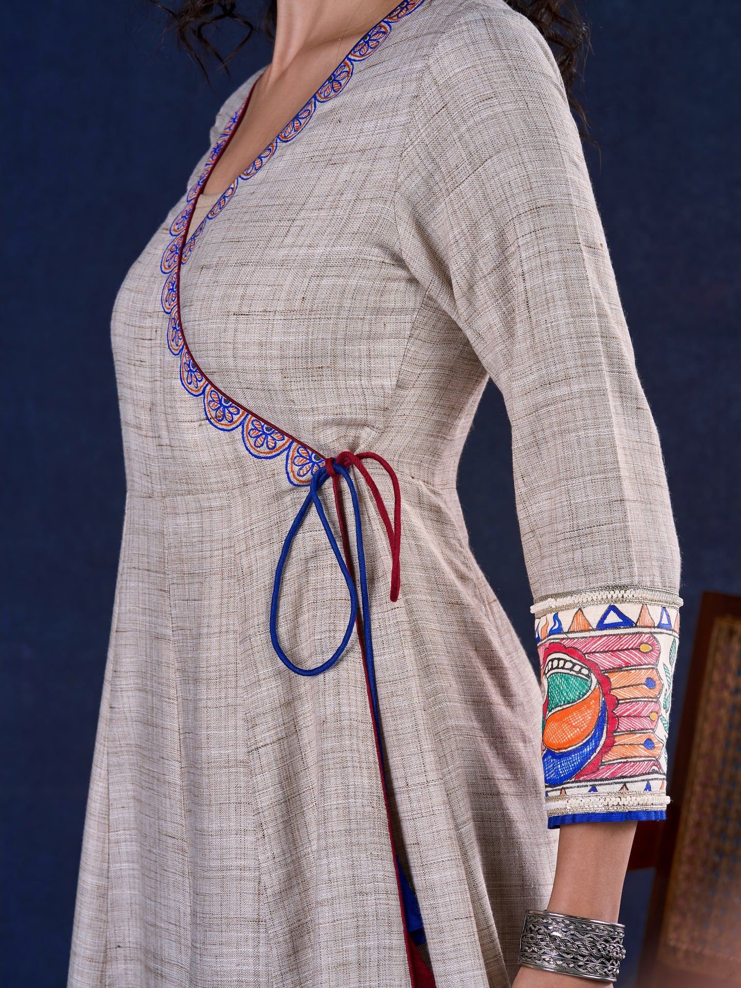 Artisanal Beige Handloom Cotton Angarkha Long Gown with Madhubani Border Embellished Neckline, Sleeve & Flare, with Vibrant Statement Tassels