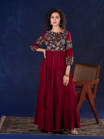 Timeless Maroon Rayon Layered Gown with Gathers and Hand Painted Kalamkari Accents featuring Puffy Sleeves and Delicate Golden Accents
