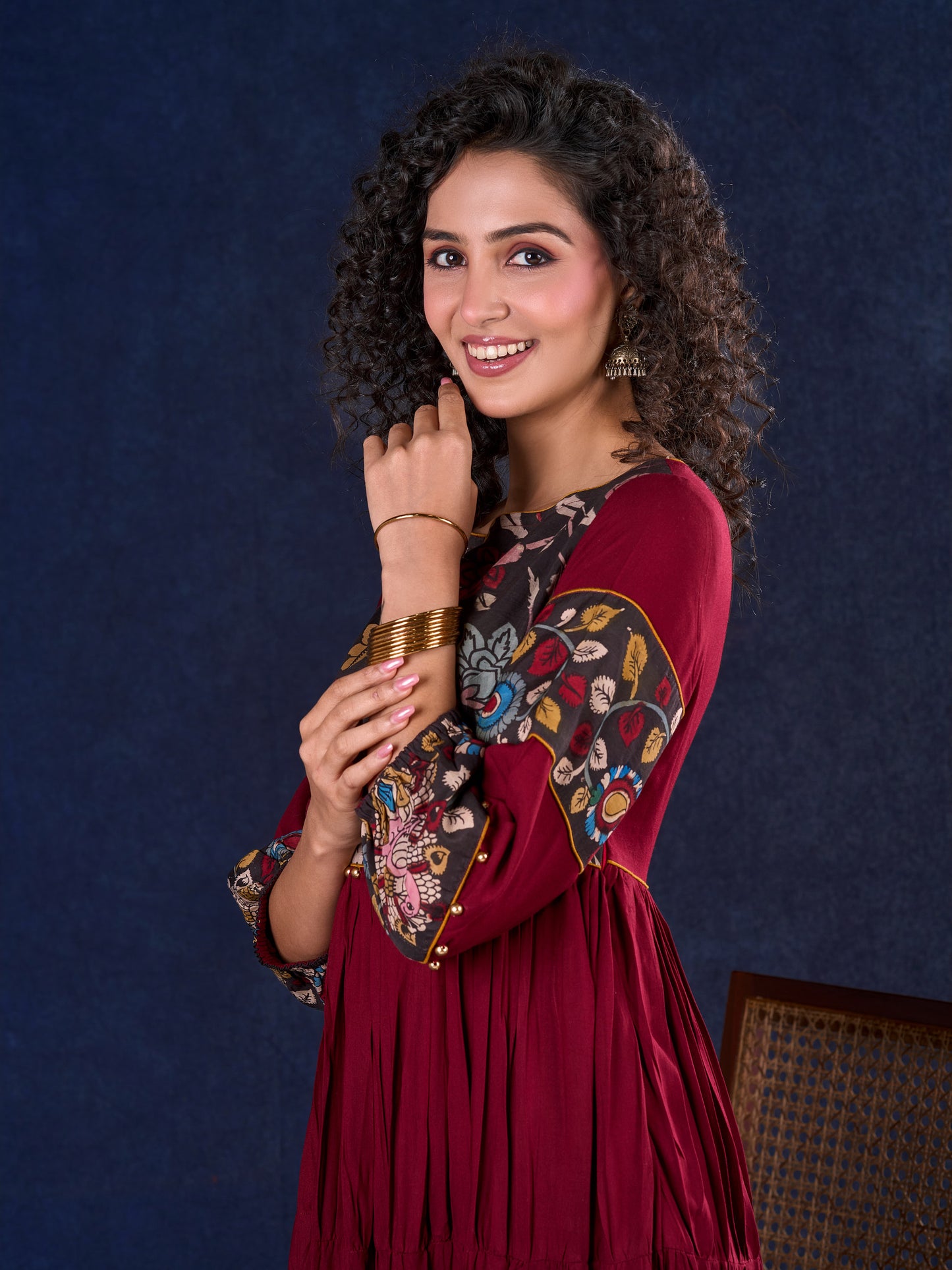 Timeless Maroon Rayon Layered Gown with Gathers and Hand Painted Kalamkari Accents featuring Puffy Sleeves and Delicate Golden Accents