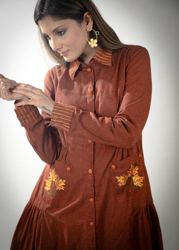 Rust cotton dress with embroidered pockets