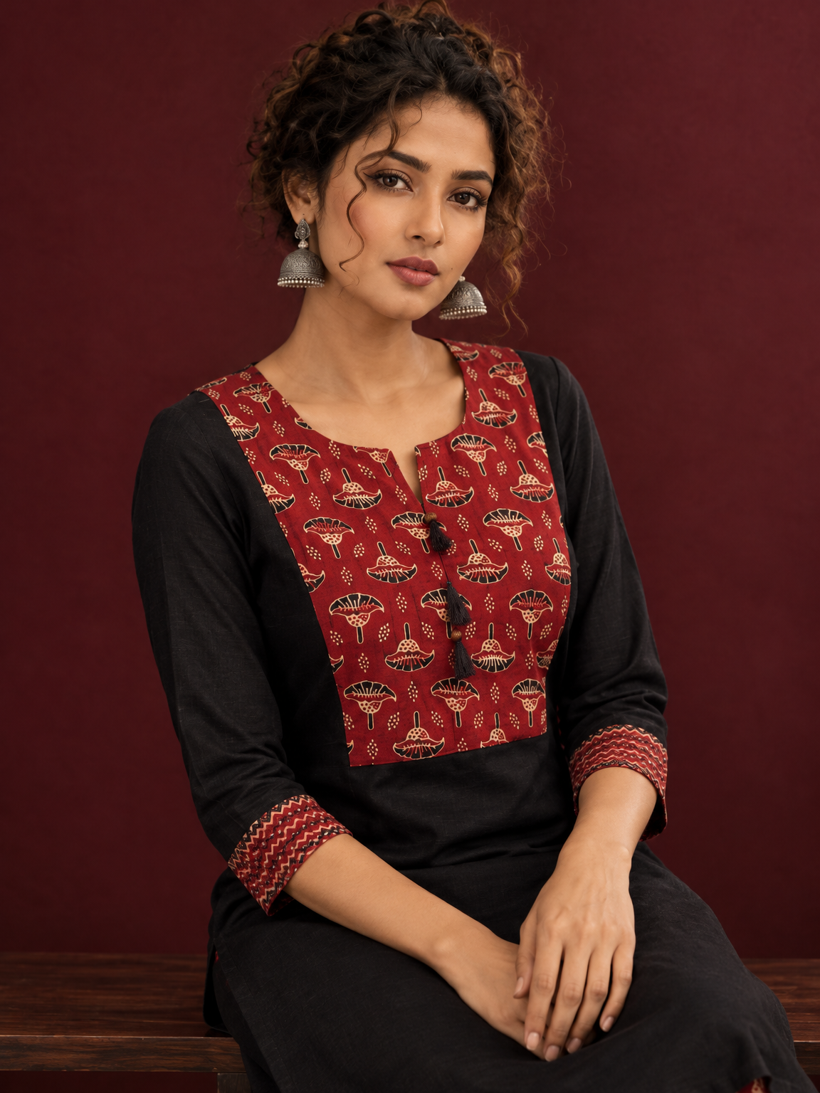Classic Black Cotton Kurta with Maroon Ajrakh Print Yoke & Coordinated Sleeve Cuffs — seated detail — view 5