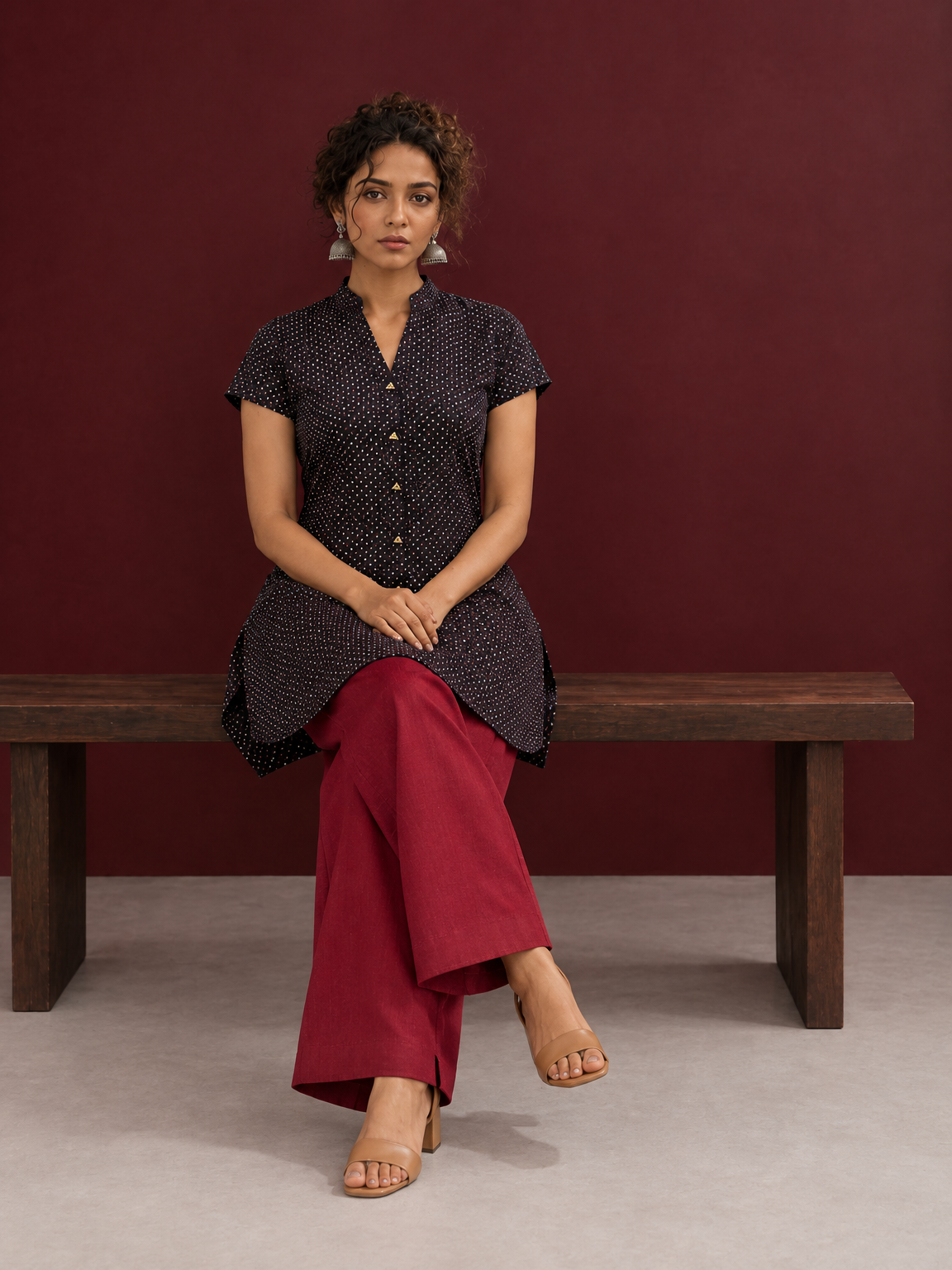 Timeless Black Cotton Tunic with Maroon Polka Dot Print and Gold Triangle Button Placket — seated — view 6