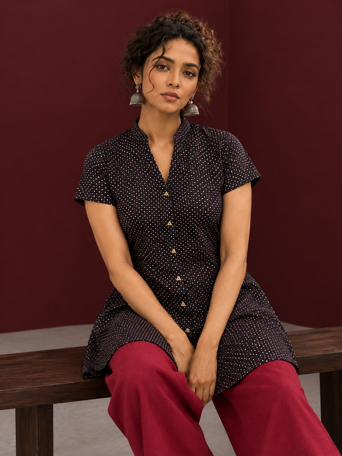 Timeless Black Cotton Tunic with Maroon Polka Dot Print and Gold Triangle Button Placket — seated detail — view 5