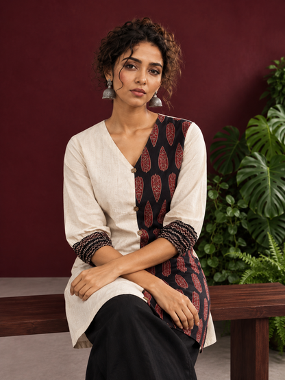 Timeless Off-White Cotton Tunic with Contrast Ajrakh Printed Leaf Panel & Coordinated Zigzag Sleeve Cuffs — seated detail