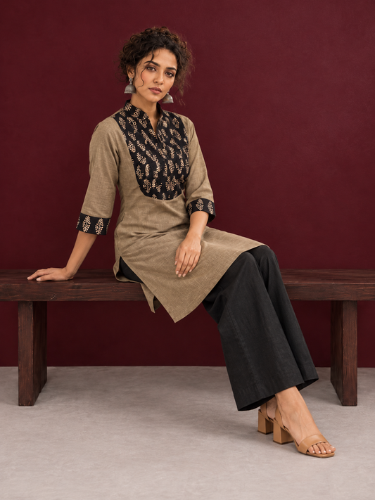 Classic Beige Cotton Kurta with Contrast Black Floral Print Yoke & Coordinated Sleeve Cuffs — seated