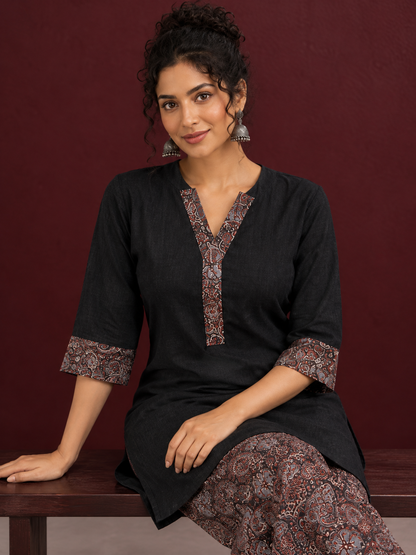 Timeless Black Cotton Tunic with Contrast Ajrakh Print V-Neck Placket & Coordinated Sleeve Cuffs — seated detail
