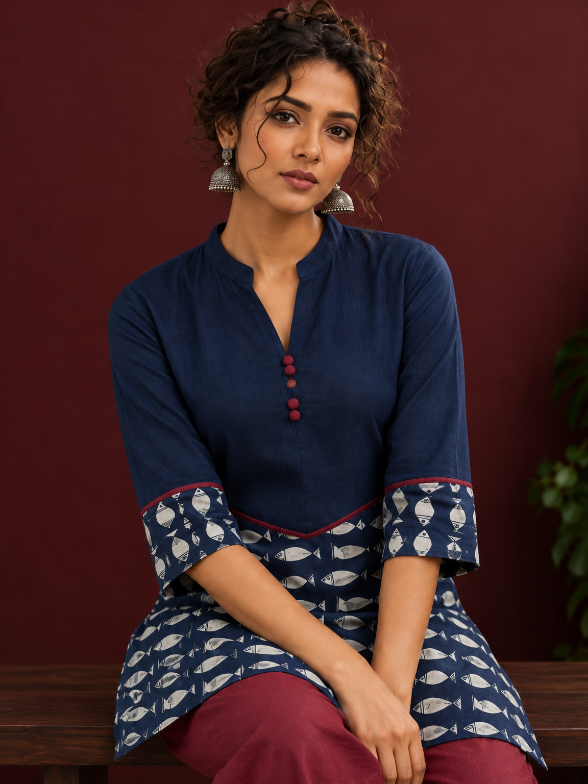 Navy Blue Cotton Tunic with Fish Print Hem Panel, Contrast Maroon Piping & Red Button Detail — seated detail — view 7