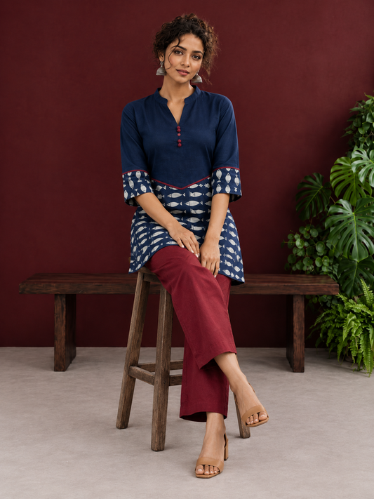 Navy Blue Cotton Tunic with Fish Print Hem Panel, Contrast Maroon Piping & Red Button Detail — seated