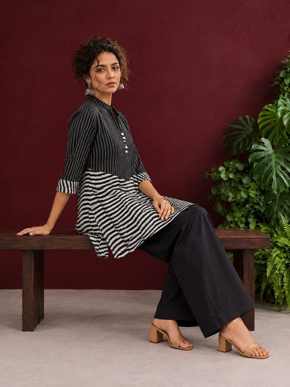 Classic Black & White Pinstripe Tunic with Contrast Striped Panel and Mandarin Collar — seated