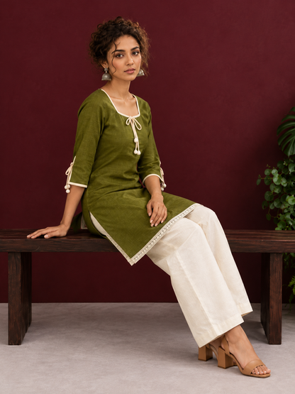 Timeless Olive Green Cotton Tunic with Tasseled Tie-Up Neckline and Contrast Lace Hem Border — seated
