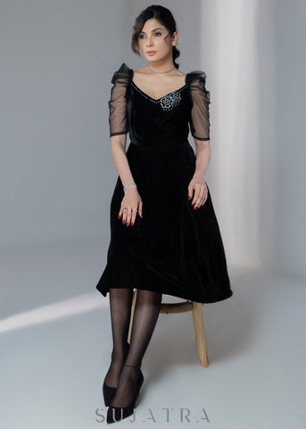 Exclusive black velvet dress with net sleeves & stone work on neckline