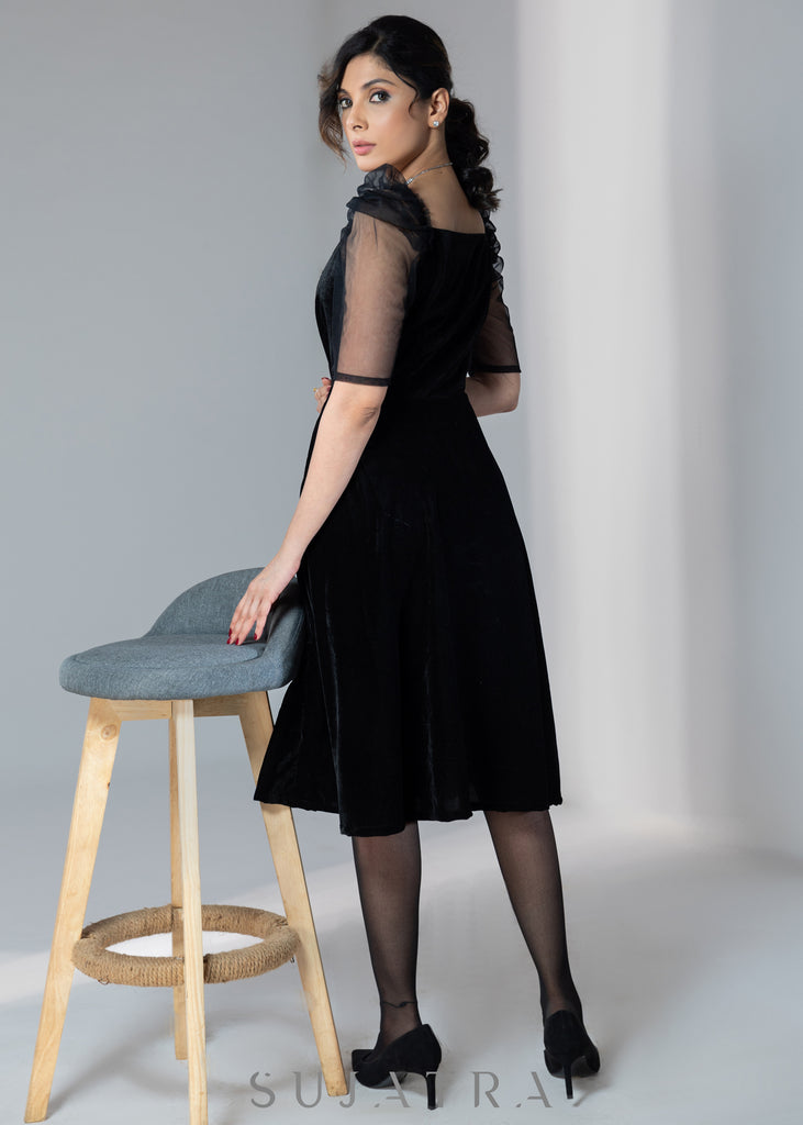 Exclusive black velvet dress with net sleeves & stone work on neckline