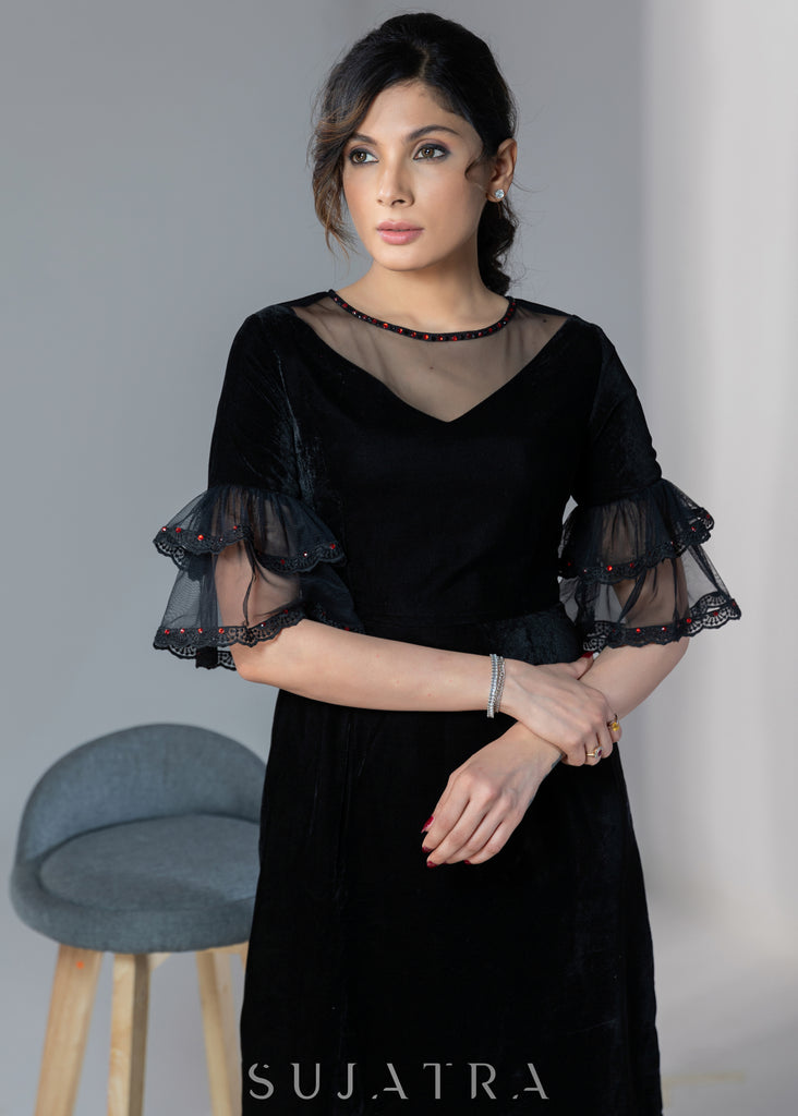 Party wear black velvet dress with net sleeves & red stone work detailing on the neck