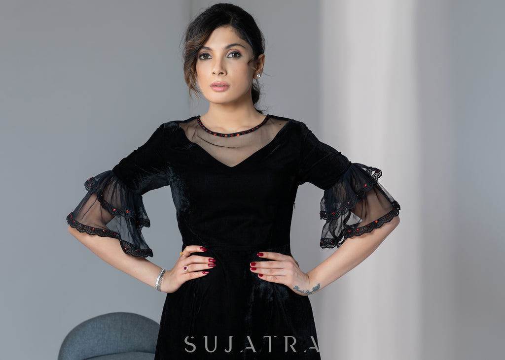 Party wear black velvet dress with net sleeves & red stone work detailing on the neck