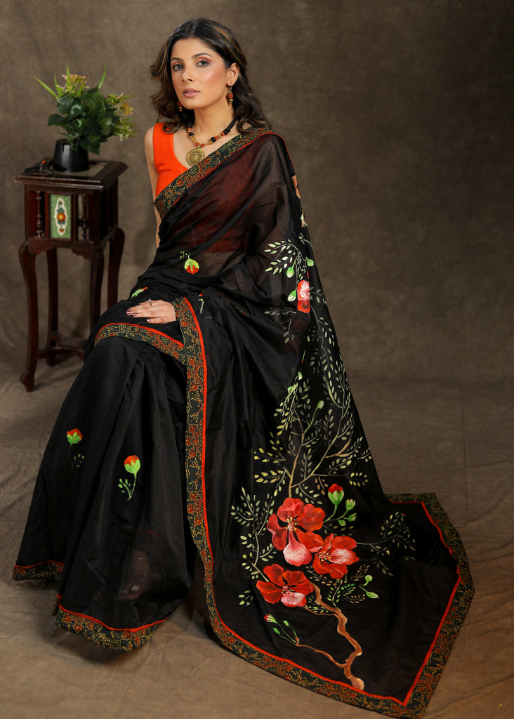 Graceful black Cotton hand painted saree with Ajrakh border