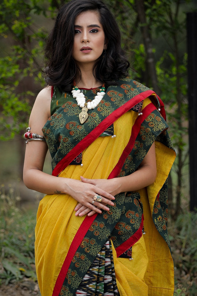 Combination of yellow handloom cotton, block printed Ajrakh border & Ikat pleats saree with ghungroos tassels