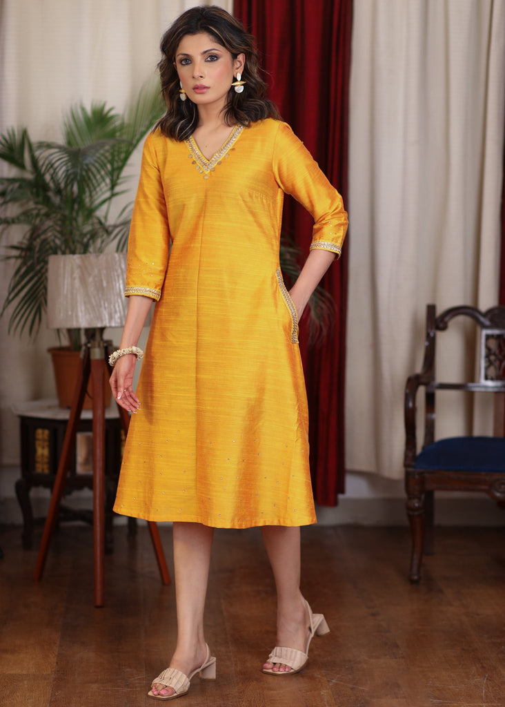 Beautiful mango cotton silk dress with pockets highlighted with zari lace and coin embellishments