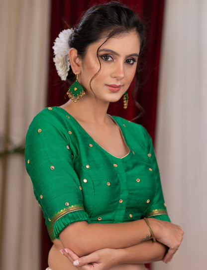Emrald green cotton silk blouse with overall mirror embroidery highlighted with banarasi lace