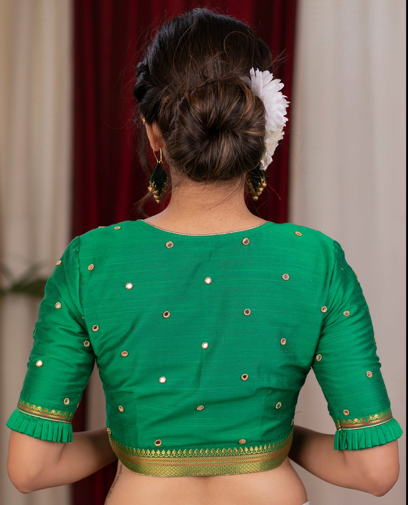 Emrald green cotton silk blouse with overall mirror embroidery highlighted with banarasi lace