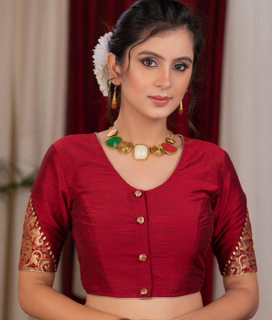 Elegant maroon cotton silk blouse highlighted with banarasi cutout