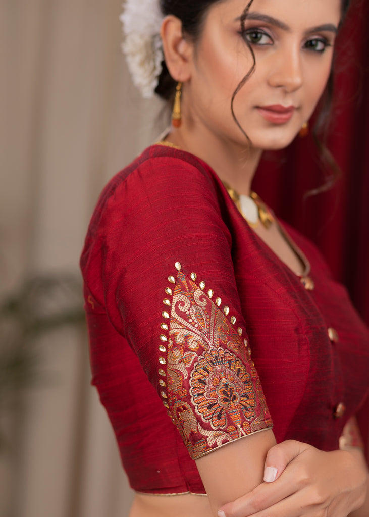 Elegant maroon cotton silk blouse highlighted with banarasi cutout on sleeves