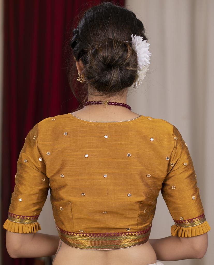 Exclusive metallic gold blouse with overall mirror embroidery highlighted with banarasi lace