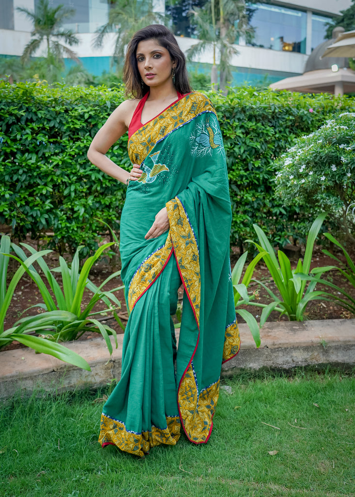 Cotton bottlegreen saree with gond hand painting with Ajrakh border