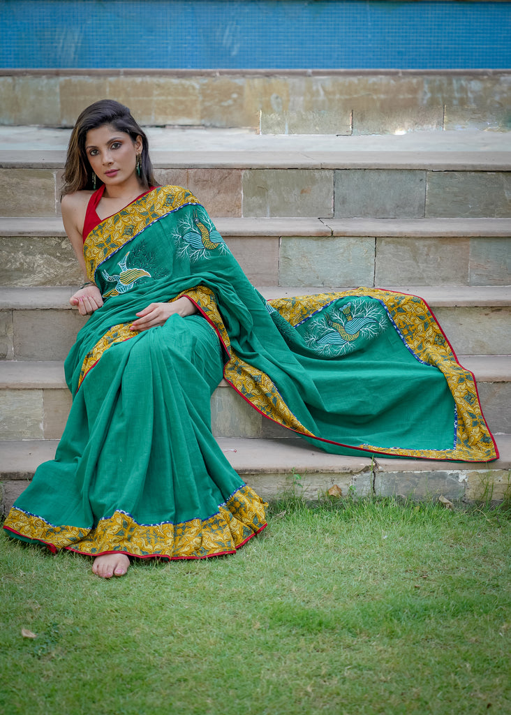 Cotton bottlegreen saree with gond hand painting with Ajrakh border