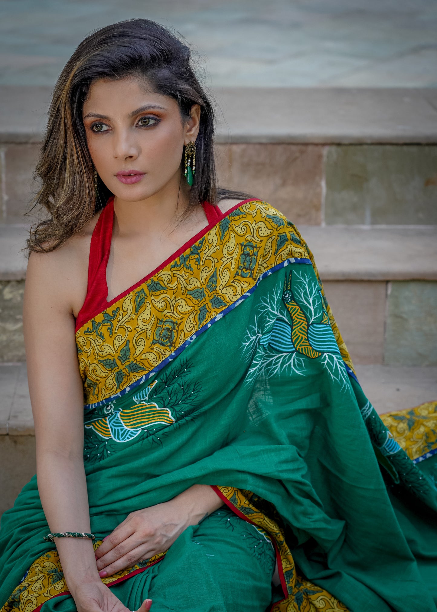 Cotton bottlegreen saree with gond hand painting with Ajrakh border