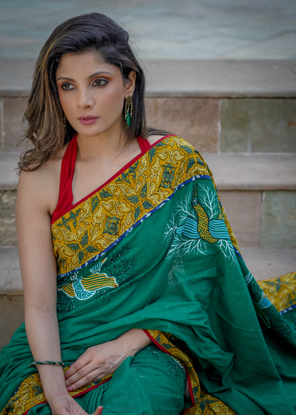Cotton bottlegreen saree with gond hand painting with Ajrakh border