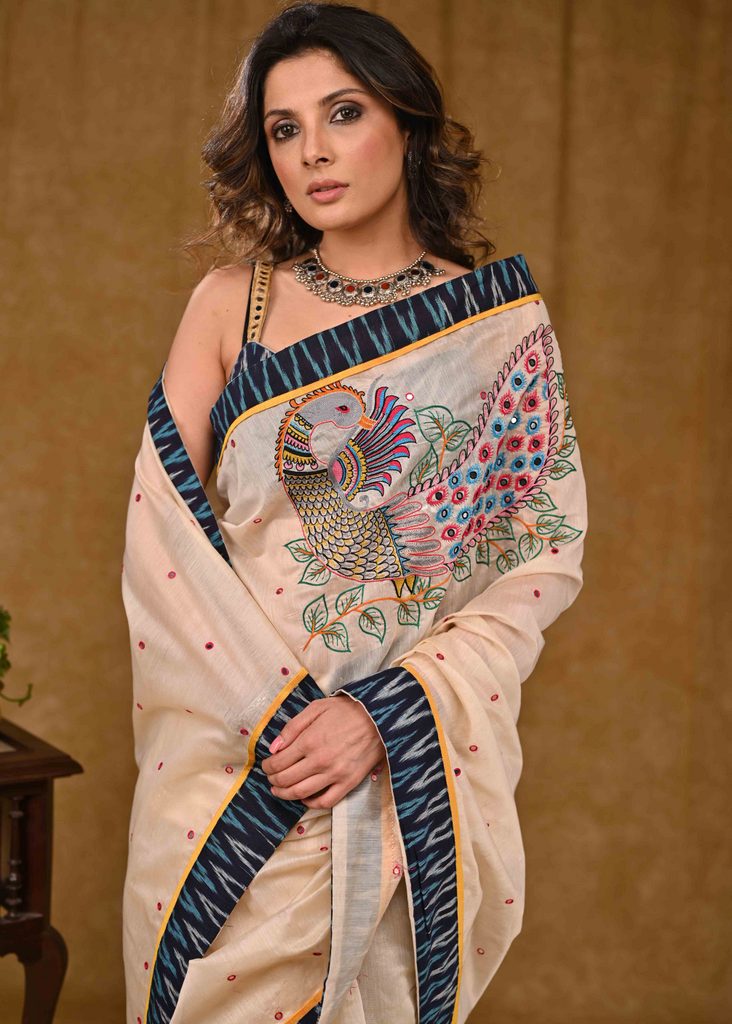 Cream Chanderi Saree with Delicate Peacock Motif Embroidery and Blue Ikaat Border