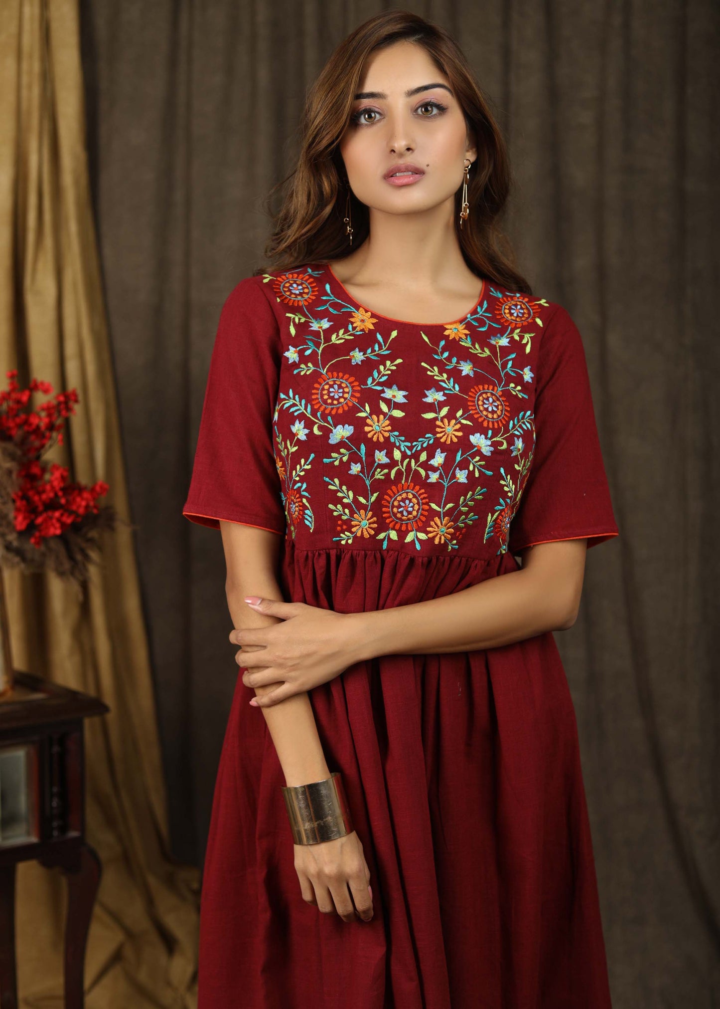 Classic maroon gathered dress with minimal floral embroidery and elbow sleeves