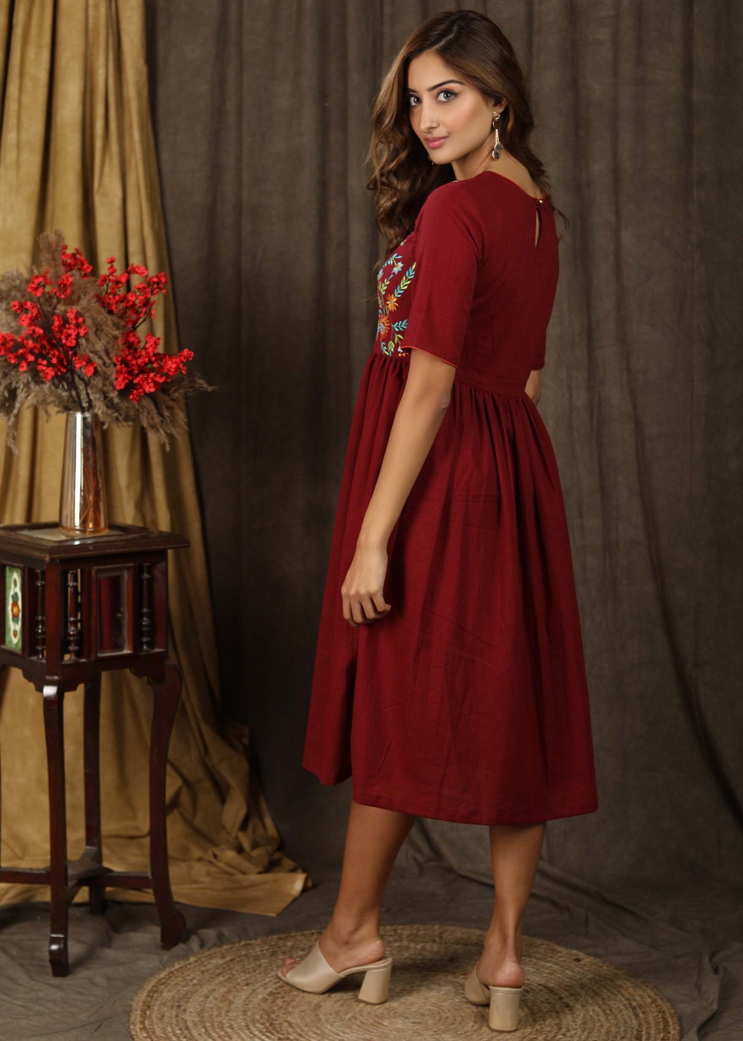 Classic maroon gathered dress with minimal floral embroidery and elbow sleeves
