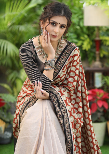 Artisanal cream cotton saree with printed pallu and highlighted with Ajrakh border