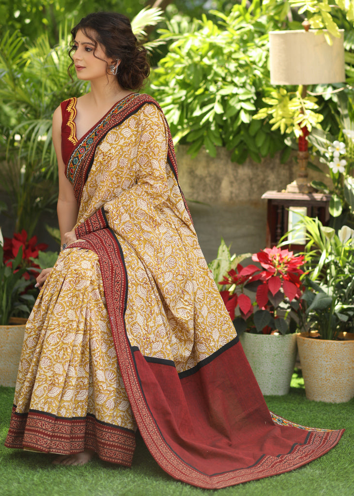 Exclusive mustard printed Cotton saree Accentuated with Ajrakh and Mirror border