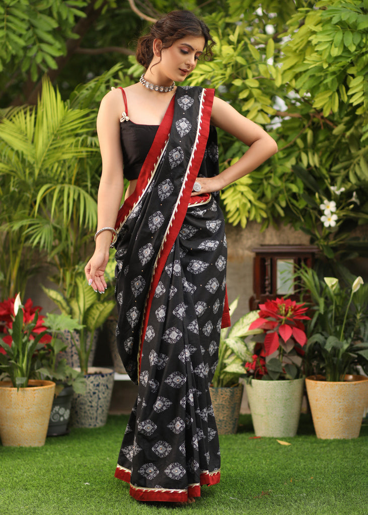 Elegant black printed Cotton saree with maroon Gota Patti border and stone embellishment