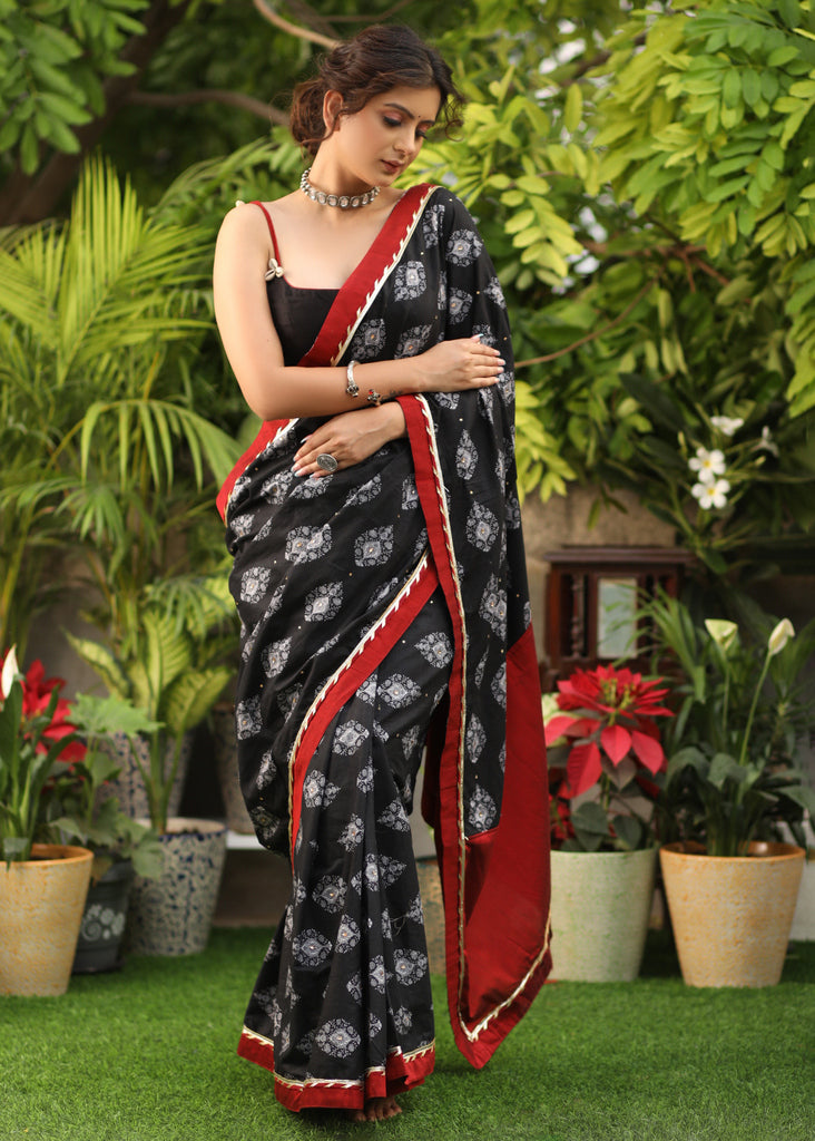 Elegant black printed Cotton saree with maroon Gota Patti border and stone embellishment