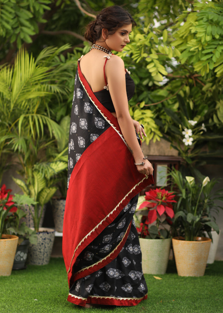 Elegant black printed Cotton saree with maroon Gota Patti border and stone embellishment