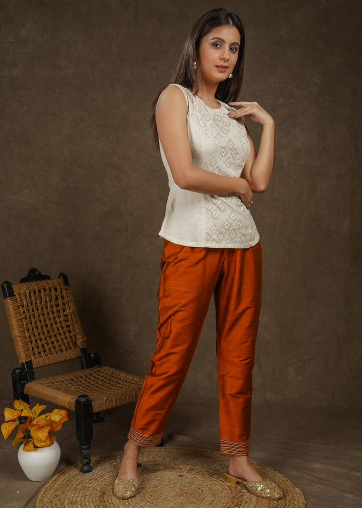 Classy rust cotton silk narrow fitted pant with beautiful stripe embroidery on hemline