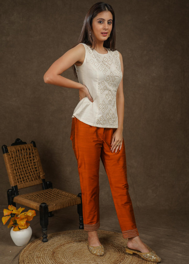 Classy rust cotton silk narrow fitted pant with beautiful stripe embroidery on hemline