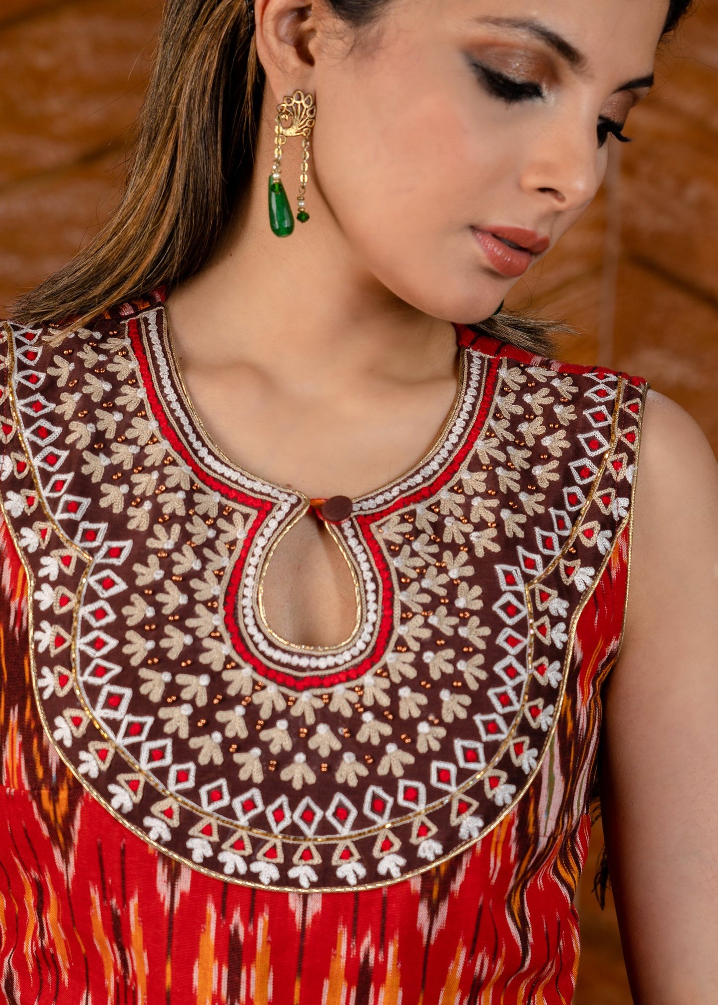 Exclusive sleeveless ikat kurta with heavy hand embroidery on neckline.