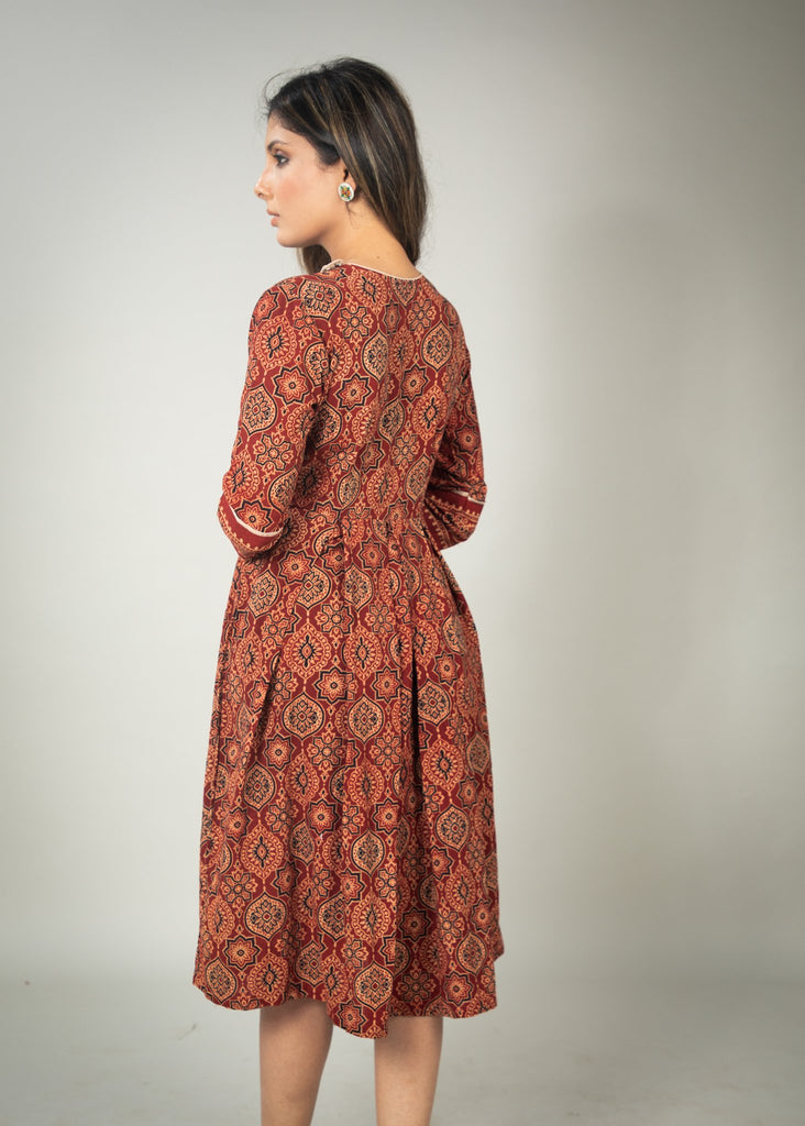 Rust Ajrakh printed dress with asymmetrical neckline & contrast detailing