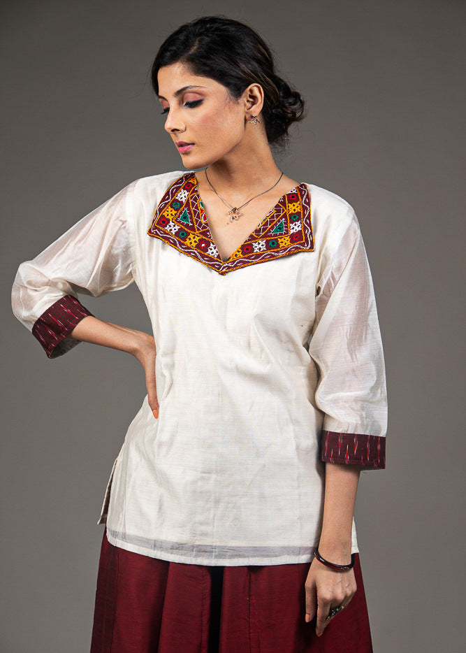 Exclusive white chanderi top with hand embroidered kutchi mirror work collar