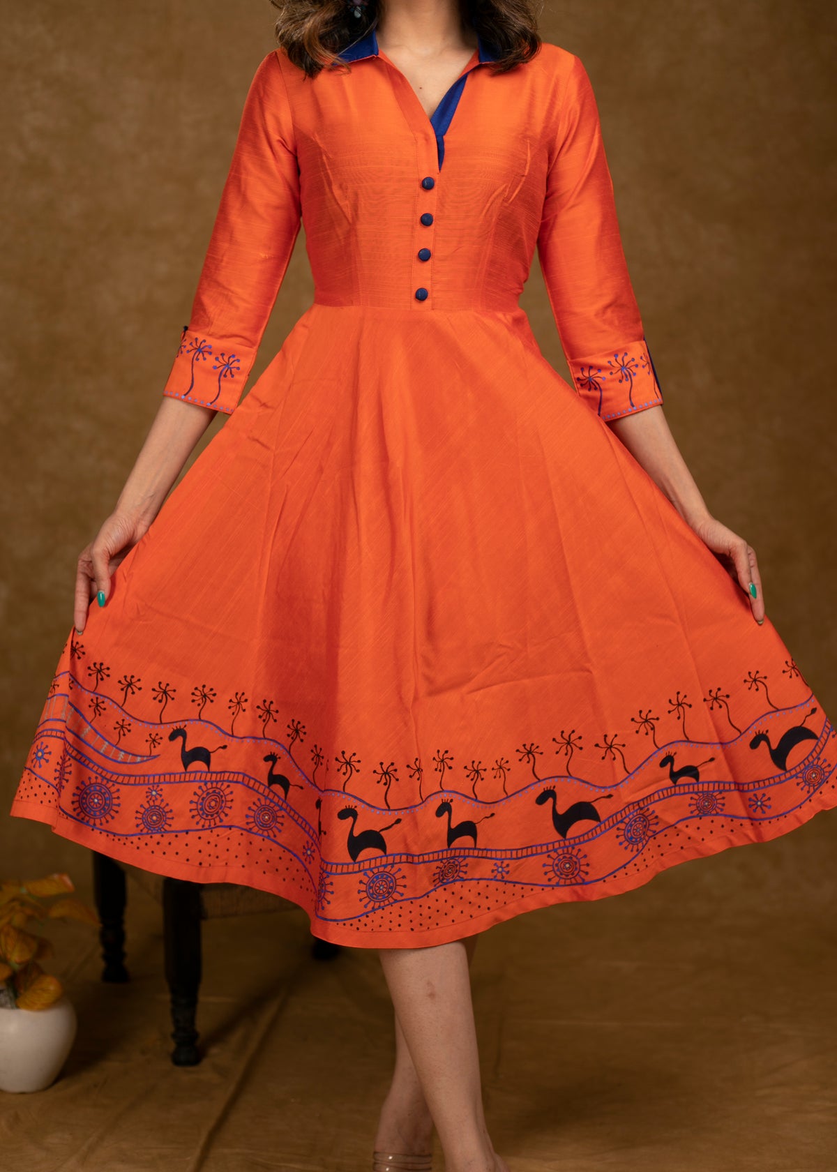 Dussehra Sale — Exclusive Orange Cotton Silk Dress with Gond Painting on Hemline and Sleeves