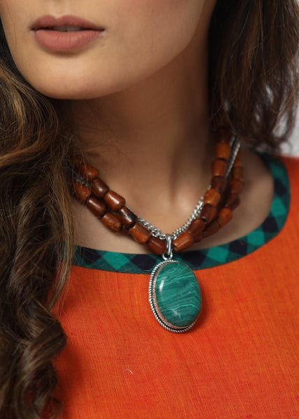 Handmade neckpiece with dark brown wooden beads combined with forest green stone pendant